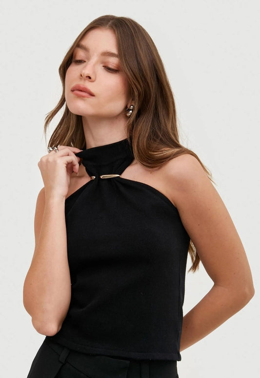 Modelo vestindo a regata feminina gola alta preta. Destaque para o detalhe dourado e acessórios prata.
